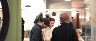 Gruppe von vier Mitarbeitenenden unterhält sich während einer Retro